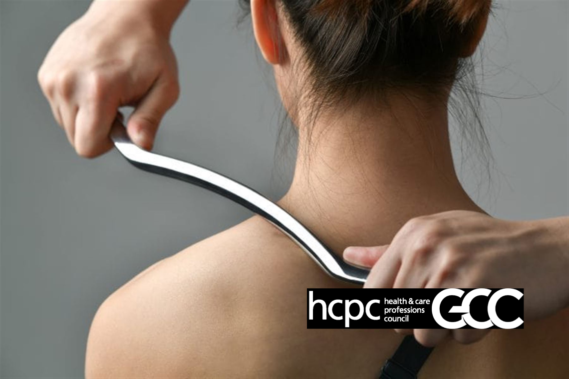 A therapist using a stainless-steel IASTM instrument along a patient's shoulder and neck.